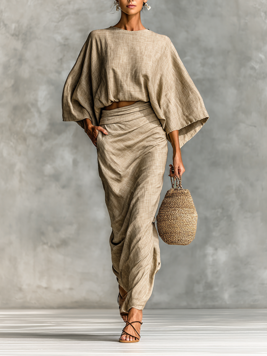 Two-piece ensemble featuring a flowing maxi skirt and oversized batwing sleeves